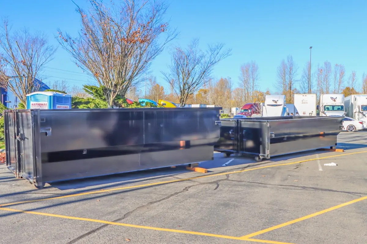 Professional dumpster rental service with roll-off container on residential driveway in Umatilla